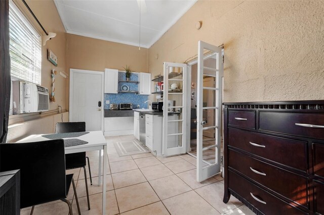 kitchen featuring open shelves, light tile patterned flooring, white cabinetry, french doors, and dishwasher