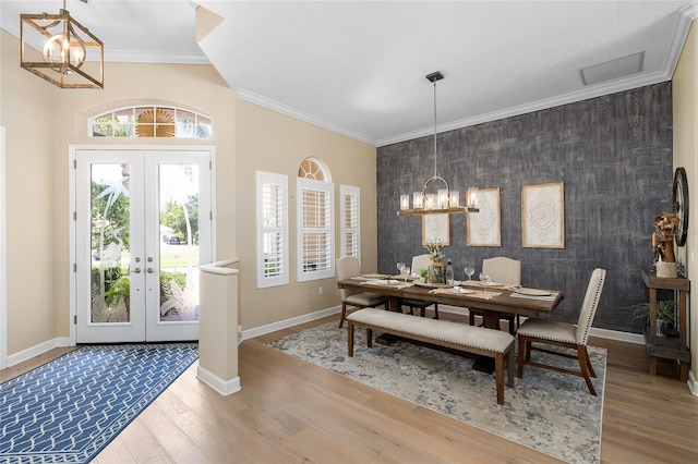 6231 Cypress Bend Ct, University Park, FL 34201 - dining room with an accent wall, a chandelier, healthy amount of natural light, crown molding, and wallpapered walls
