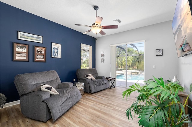 6231 Cypress Bend Ct, University Park, FL 34201 - living area with ceiling fan, wood finished floors, and baseboards