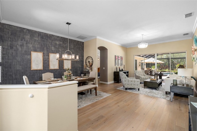 6231 Cypress Bend Ct, University Park, FL 34201 - living area with an accent wall, arched walkways, wood finished floors, baseboards, and wallpapered walls