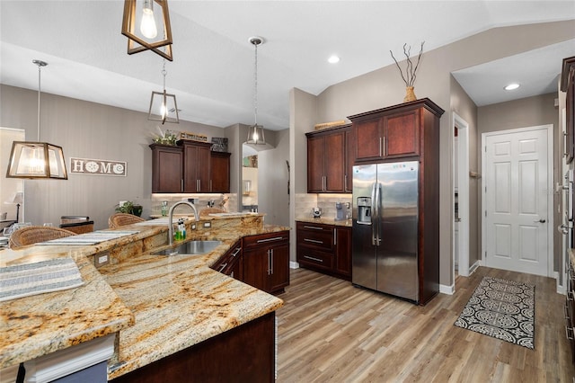 6231 Cypress Bend Ct, University Park, FL 34201 - kitchen with stainless steel refrigerator with ice dispenser, a sink, light wood finished floors, tasteful backsplash, and hanging light fixtures