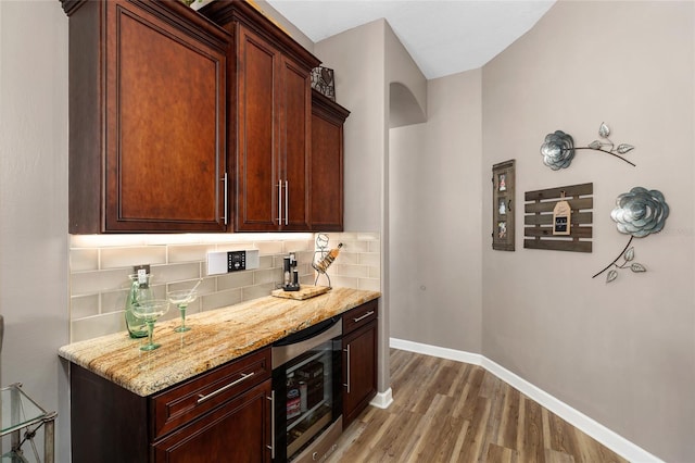 6231 Cypress Bend Ct, University Park, FL 34201 - bar with beverage cooler, light wood finished floors, tasteful backsplash, and baseboards