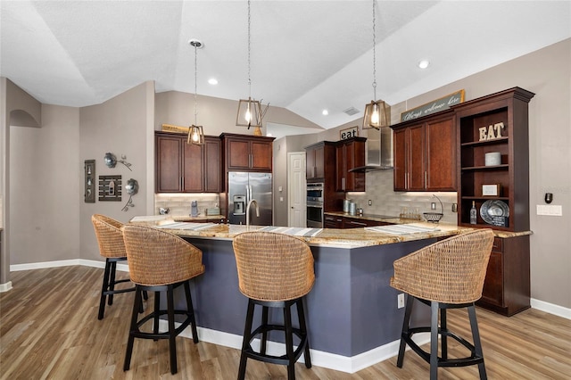 6231 Cypress Bend Ct, University Park, FL 34201 - kitchen with stainless steel appliances, wall chimney range hood, lofted ceiling, light wood-type flooring, and a kitchen breakfast bar