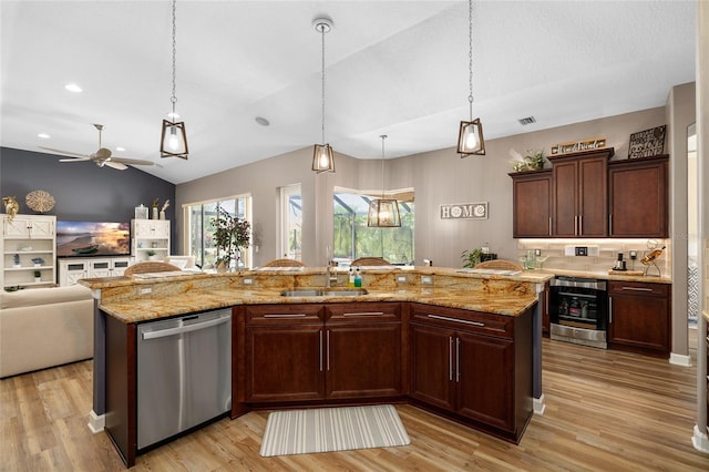 6231 Cypress Bend Ct, University Park, FL 34201 - kitchen featuring dishwasher, a sink, vaulted ceiling, open floor plan, and light wood-type flooring