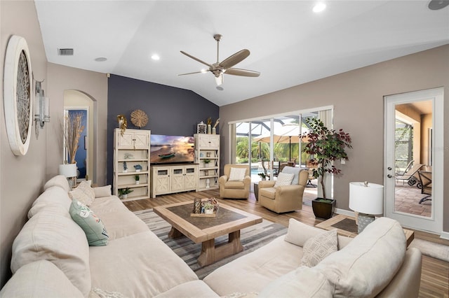 6231 Cypress Bend Ct, University Park, FL 34201 - living area featuring arched walkways, vaulted ceiling, ceiling fan, wood finished floors, and baseboards