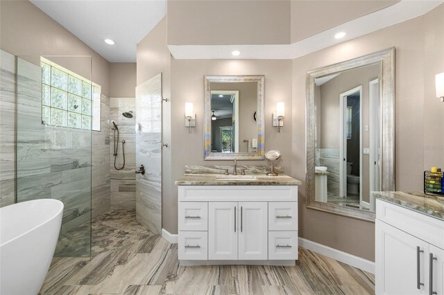 6231 Cypress Bend Ct, University Park, FL 34201 - bathroom with vanity, a walk in shower, a freestanding tub, recessed lighting, and baseboards