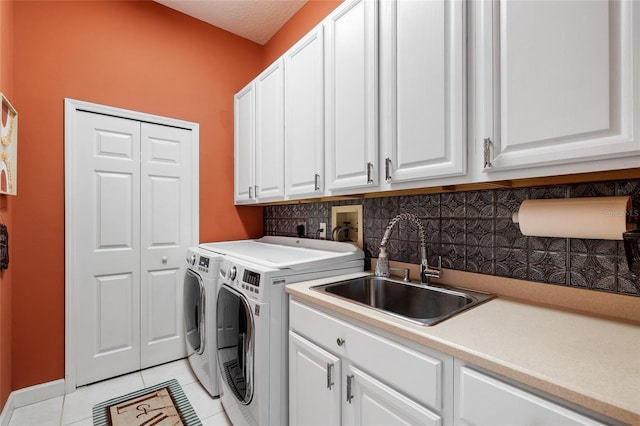 6231 Cypress Bend Ct, University Park, FL 34201 - washroom featuring cabinet space, washing machine and dryer, light tile patterned flooring, and baseboards
