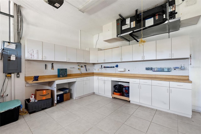 6231 Cypress Bend Ct, University Park, FL 34201 - kitchen featuring electric panel, tasteful backsplash, light tile patterned flooring, and a textured ceiling