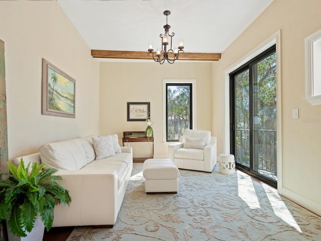 living area featuring beamed ceiling and an inviting chandelier
