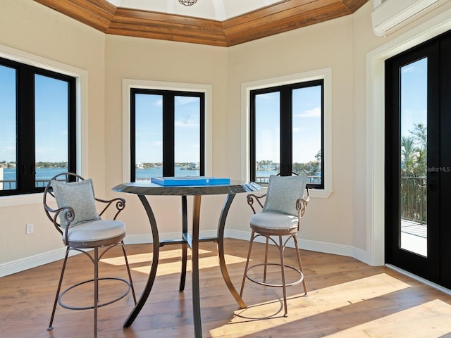 sunroom with french doors, plenty of natural light, and a wall mounted AC