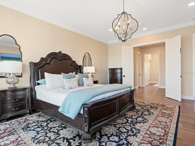 bedroom with ornamental molding, recessed lighting, wood finished floors, and a chandelier