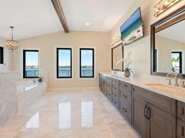 bathroom featuring vaulted ceiling with beams, double vanity, marble finish floor, a sink, and a garden tub