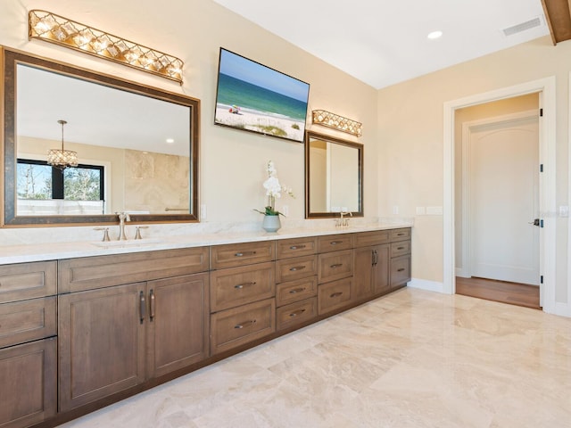 bathroom with a sink, double vanity, visible vents, a notable chandelier, and marble finish floor