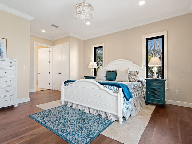 bedroom with visible vents, multiple windows, and dark wood-type flooring