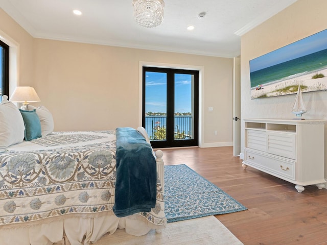 bedroom featuring recessed lighting, wood finished floors, access to exterior, ornamental molding, and baseboards