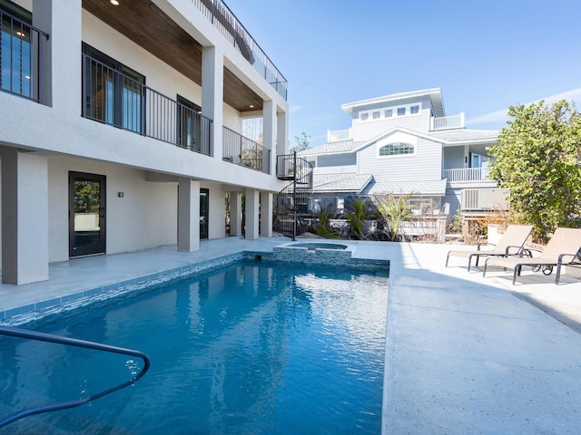 view of pool featuring a patio area and a pool with connected hot tub