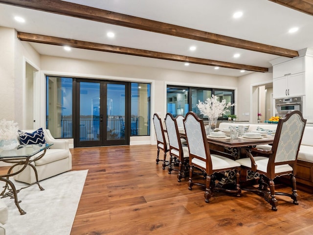 dining space with recessed lighting, light wood-style flooring, and beamed ceiling