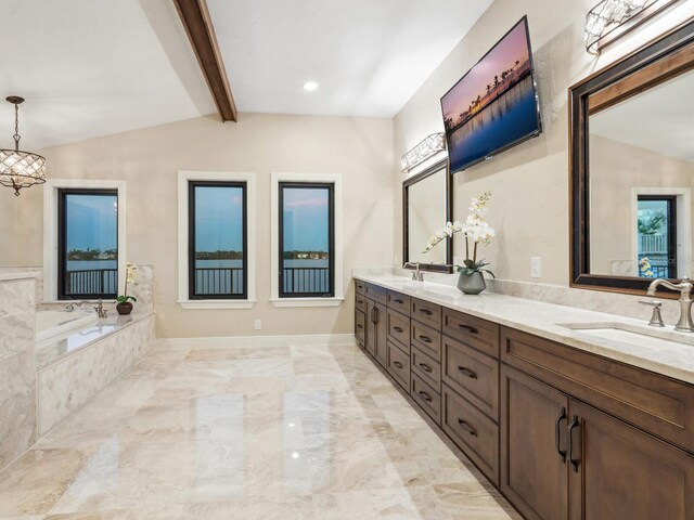full bathroom with vaulted ceiling with beams, double vanity, marble finish floor, a bath, and a sink