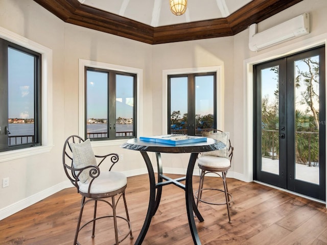 sunroom featuring a wall unit AC and french doors