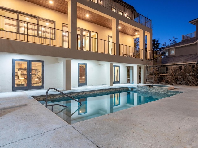 back of house featuring a patio, stucco siding, and a balcony
