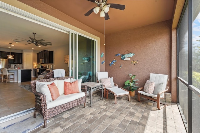 sunroom / solarium featuring a ceiling fan