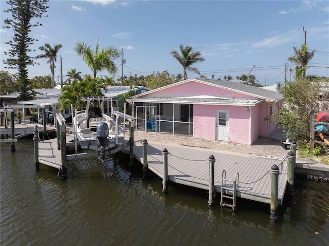 view of dock featuring boat lift and a water view
