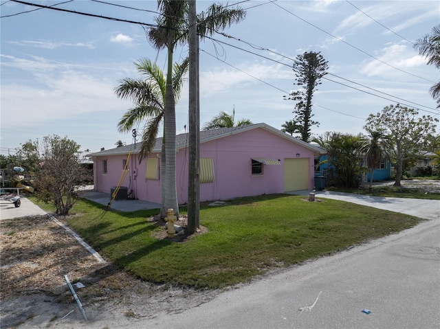 view of home's exterior featuring a lawn, concrete driveway, stucco siding, and an attached garage