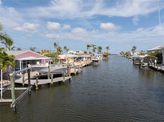dock area with boat lift and a water view