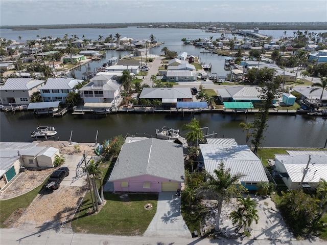drone / aerial view featuring a residential view and a water view