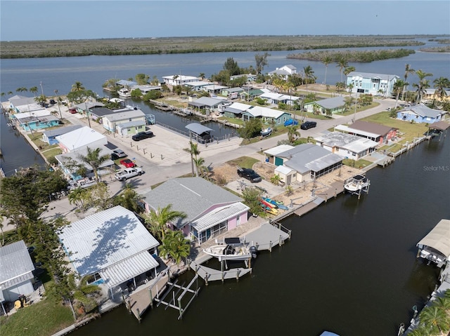 birds eye view of property featuring a water view and a residential view