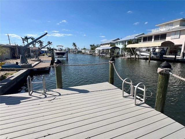 dock area with a residential view and a water view