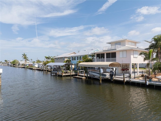 dock area featuring a balcony and a water view