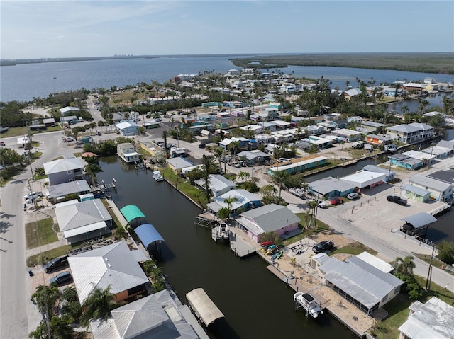 drone / aerial view featuring a water view and a residential view