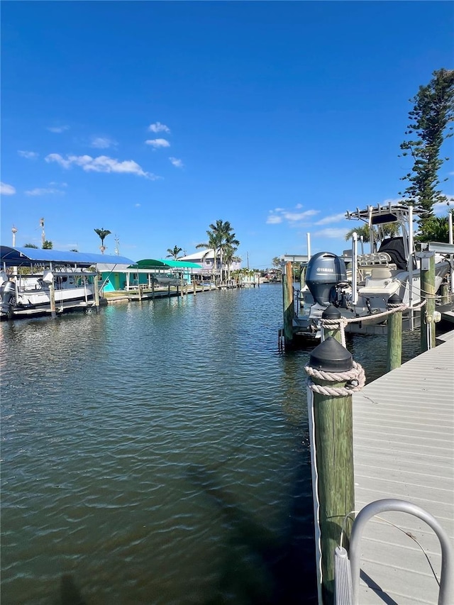 view of dock featuring boat lift and a water view