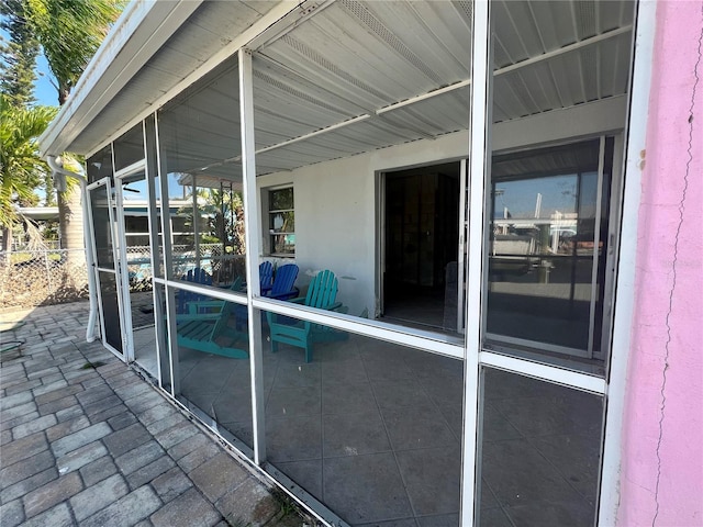 exterior space featuring stucco siding, a sunroom, and a patio area