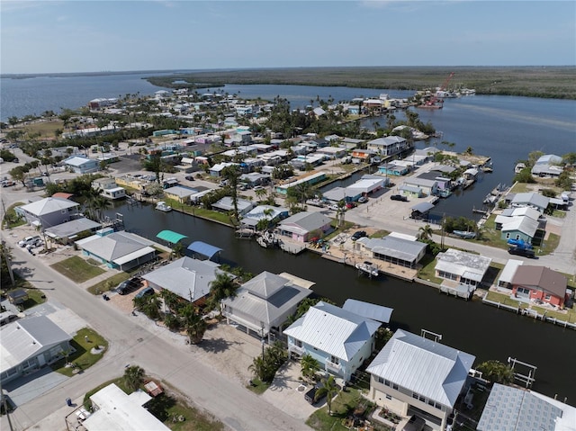 birds eye view of property with a water view and a residential view