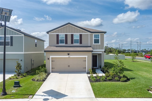 10464 Ladybug Cv, Parrish, FL 34219 - view of front of house with a shingled roof, concrete driveway, board and batten siding, a front yard, and an attached garage