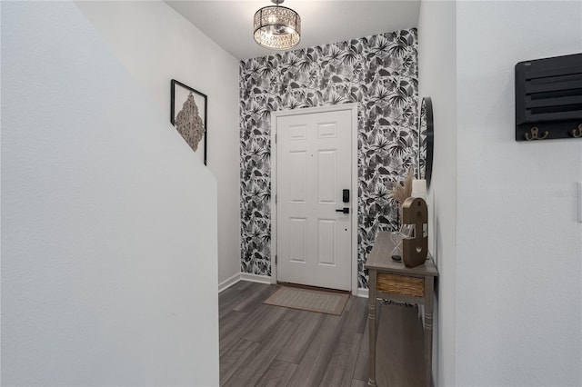 10464 Ladybug Cv, Parrish, FL 34219 - entryway featuring wallpapered walls, baseboards, wood finished floors, and an accent wall