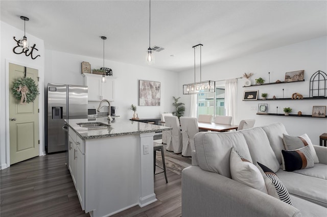 10464 Ladybug Cv, Parrish, FL 34219 - kitchen with stainless steel refrigerator with ice dispenser, a sink, a chandelier, open floor plan, and a breakfast bar area