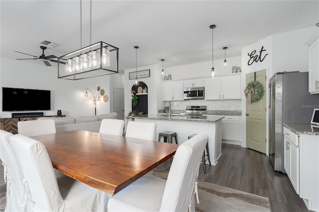 10464 Ladybug Cv, Parrish, FL 34219 - dining area with ceiling fan and dark wood-style flooring
