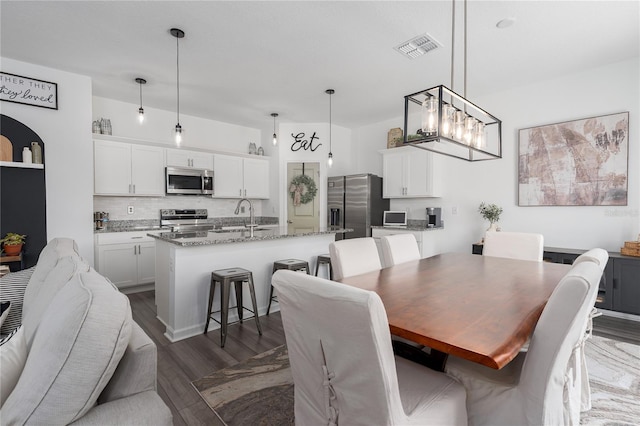 10464 Ladybug Cv, Parrish, FL 34219 - dining space with dark wood-type flooring