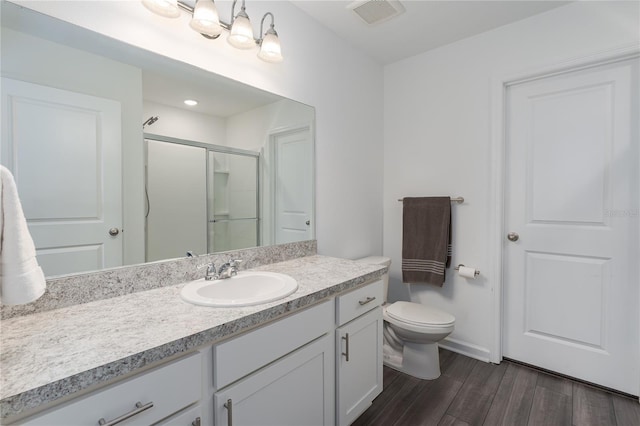 10464 Ladybug Cv, Parrish, FL 34219 - bathroom with a stall shower, wood finished floors, vanity, toilet, and baseboards