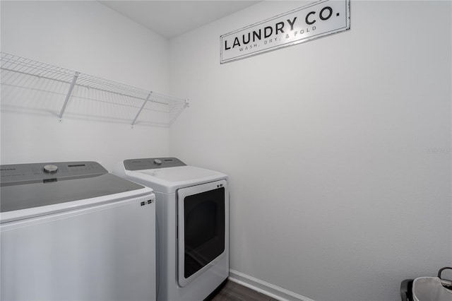 10464 Ladybug Cv, Parrish, FL 34219 - clothes washing area with separate washer and dryer, baseboards, and dark wood-style flooring