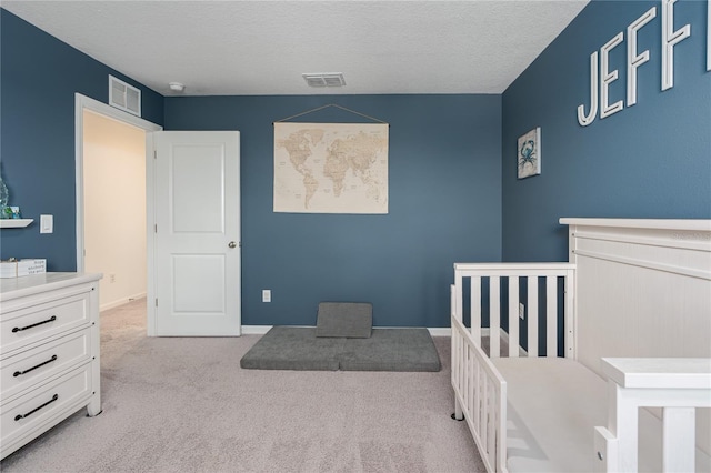 10464 Ladybug Cv, Parrish, FL 34219 - bedroom featuring carpet, a textured ceiling, and a nursery area