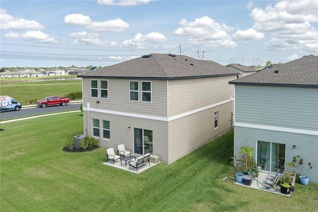 10464 Ladybug Cv, Parrish, FL 34219 - back of house featuring cooling unit, a lawn, a patio area, a shingled roof, and stucco siding