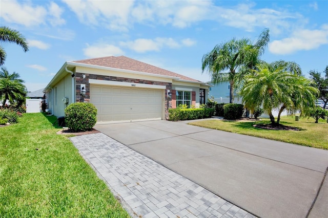 view of front of property with roof with shingles, a front yard, driveway, and an attached garage