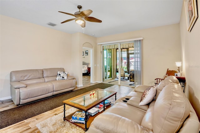 living area with ceiling fan, baseboards, wood finished floors, and visible vents