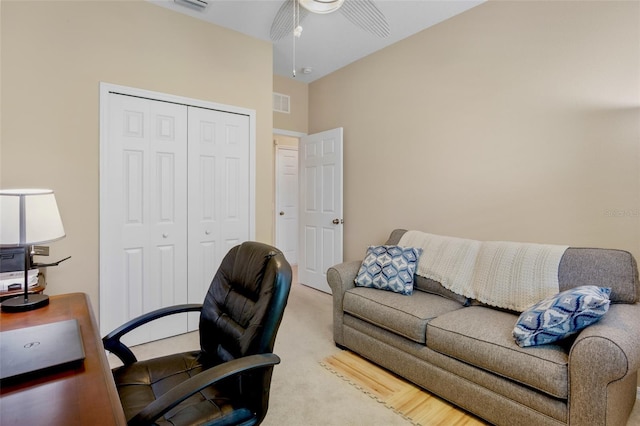 carpeted office space with visible vents and ceiling fan