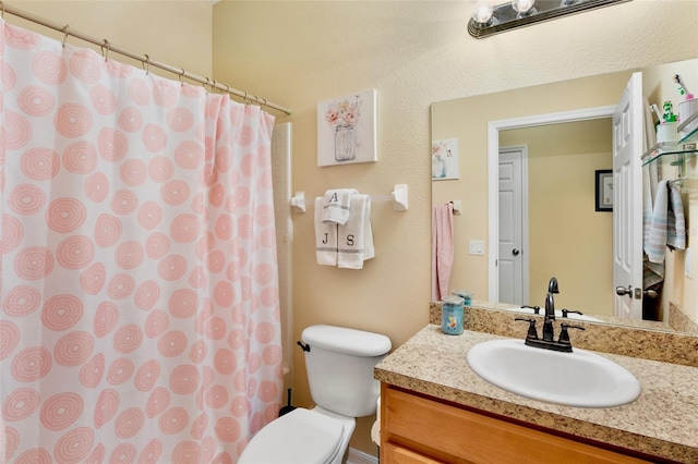 bathroom with vanity, toilet, and curtained shower