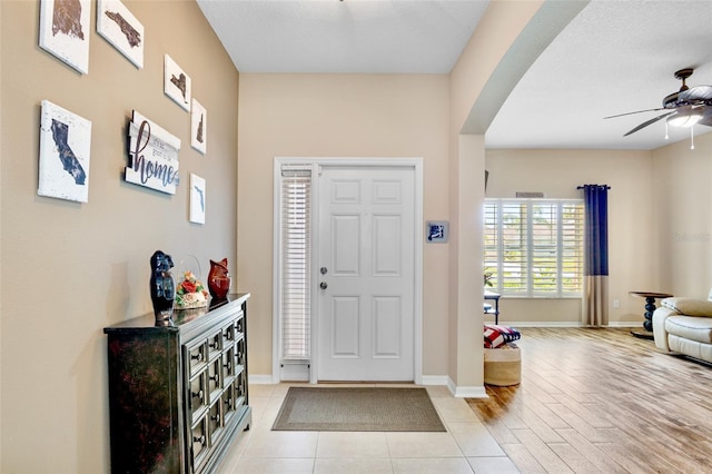 entrance foyer with a ceiling fan and baseboards